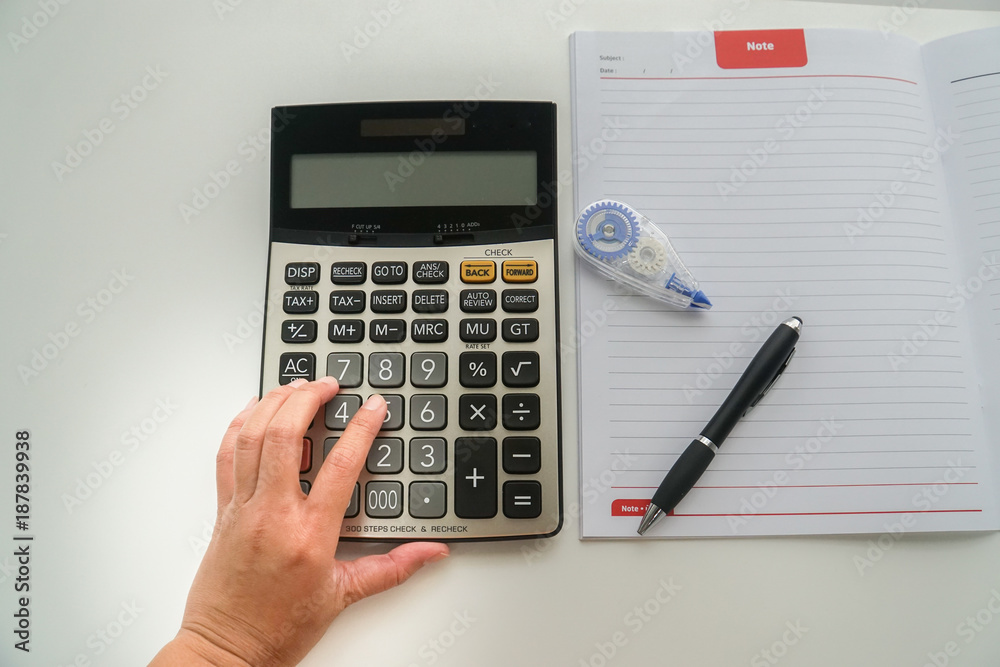 top view close up accountant with calculator, pen and correction fluid for tax and company income calculation top view close up accountant with calculator, pen and correction fluid for tax and company income calculation