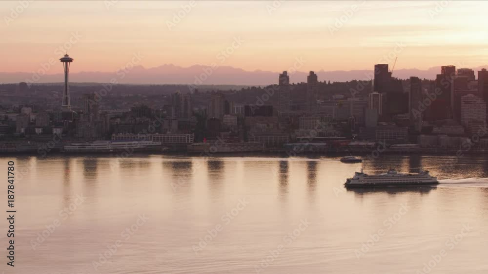 Seattle, Washington circa-2017, Aerial view of Seattle and ferry at sunrise. Shot with Cineflex and RED Epic-W Helium. Seattle, Washington circa-2017, Aerial view of Seattle and ferry at sunrise. Shot with Cineflex and RED Epic-W Helium.