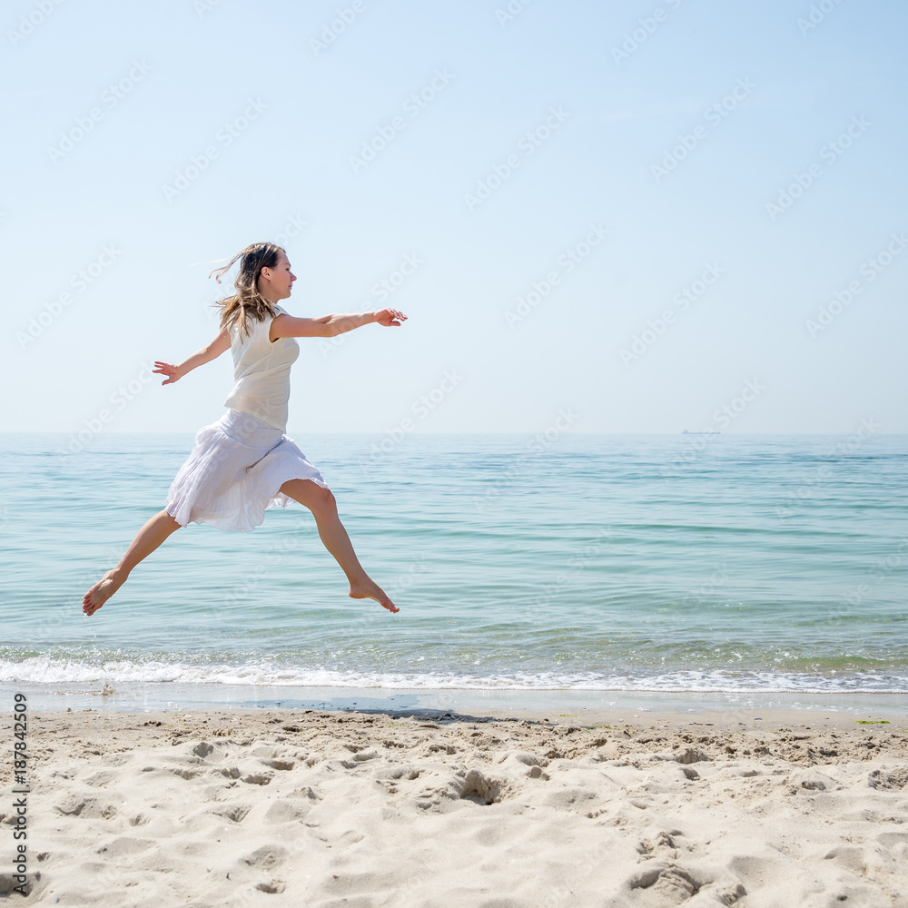 Happy beautiful young girl jumping