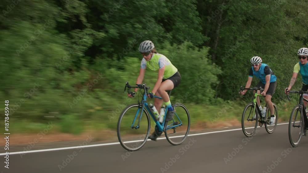 Tracking shot of a group of cyclists on country road. Fully released for commercial use. Tracking shot of a group of cyclists on country road. Fully released for commercial use.