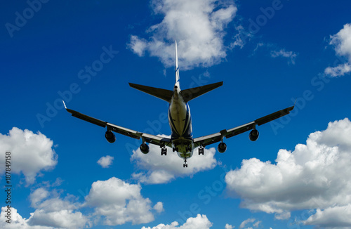 The plane on a background of blue sky and white clouds.