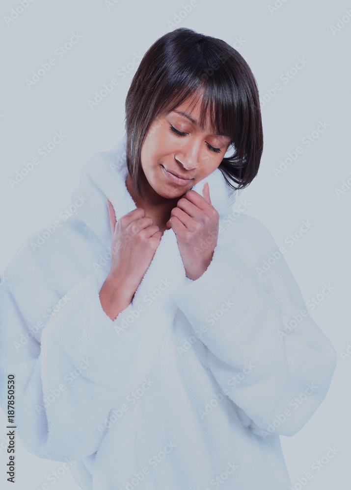 Cute young woman enjoying the feeling of her bathrobe. Cute young woman enjoying the feeling of her bathrobe.