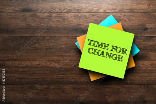 Time For Change, the phrase is written on multi-colored stickers, on a brown wooden background. Business concept, strategy, plan, planning.