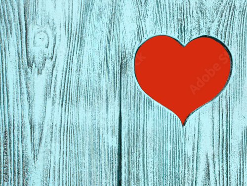 Red heart carved in a wooden board. Background.