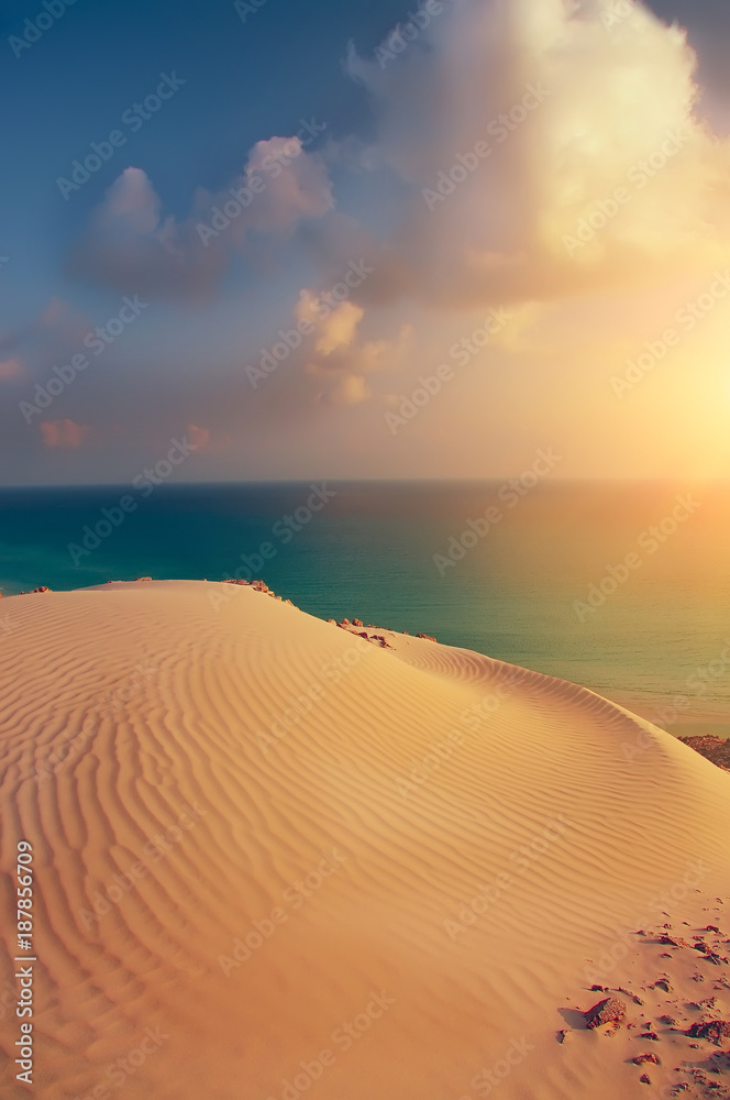 beautiful view of the sunset at the sea with a sand dune. Sea calm sunset view.
