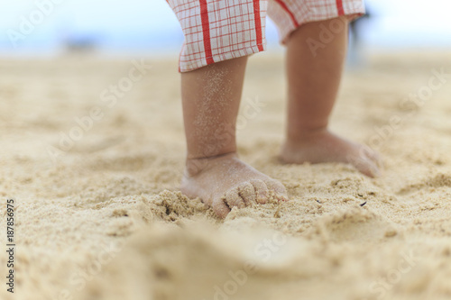 A baby legs on a beach photo