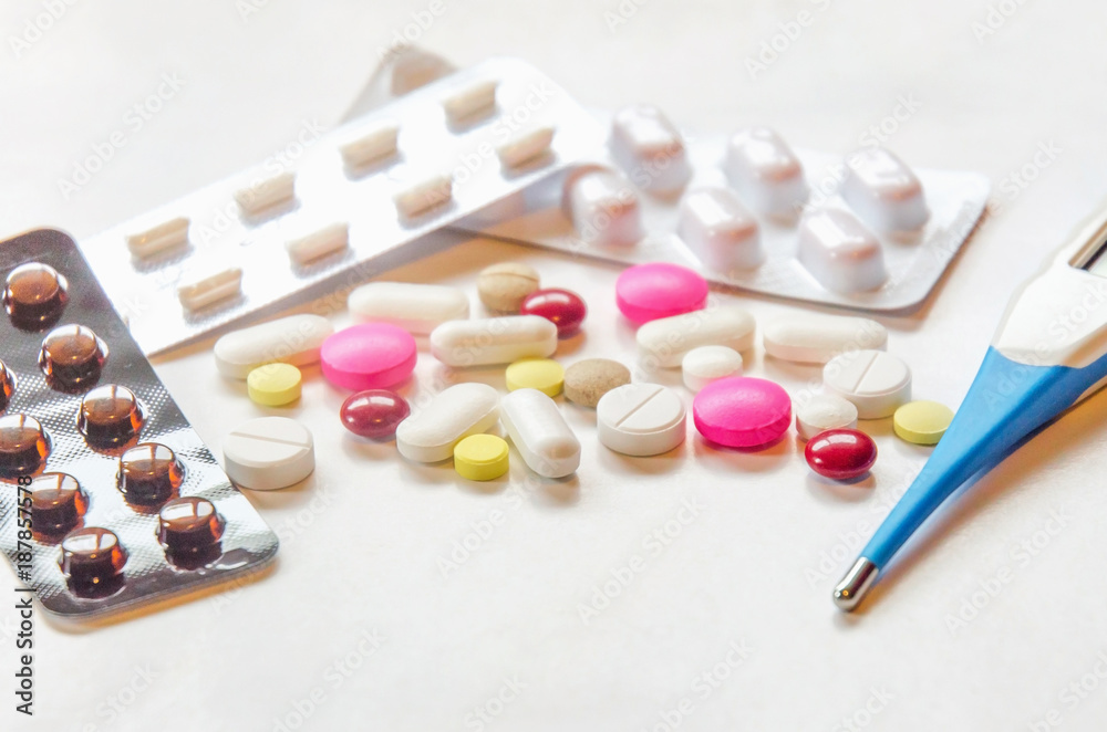 Close-up of the pills on the white background, Pack of tablet drug and capsule pills on the floor, Pile of the drug and pills on the white background. Close-up of the pills on the white background, Pack of tablet drug and capsule pills on the floor, Pile of the drug and pills on the white background.