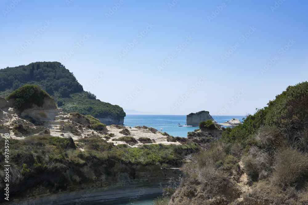 Corfu - July 2017: People swim to the sea and dive from a cliff to Corfu in July 2017 in Corfu, Greece.