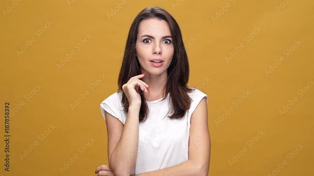 Young cheerful woman standing isolated over yellow background have an idea.