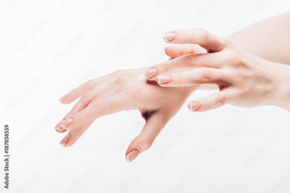 cropped shot of woman applying moisturizing cream on hand isolated on white cropped shot of woman applying moisturizing cream on hand isolated on white
