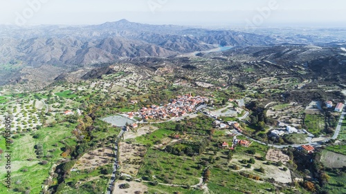 Aerial bird eye view of famous landmark tourist destination valley Kato Lefkara village, Larnaca, Cyprus. Ceramic tiled house roofs, at south of Troodos hills, Kionia and river Sirkatis from above. photo