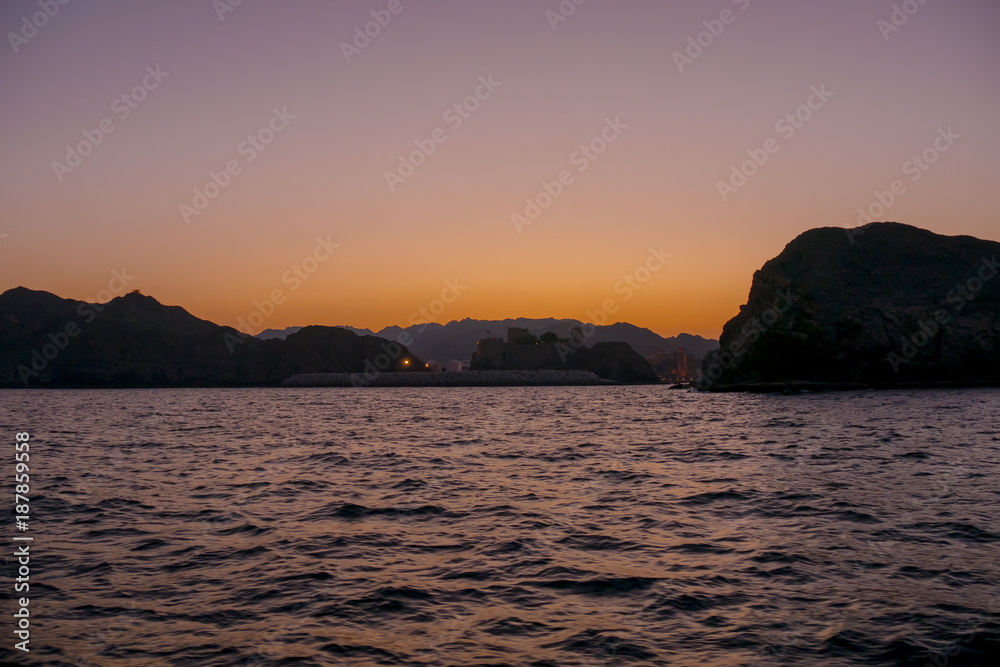 Sunset across Port of Sultan Qaboos in Muscat, Oman Sunset across Port of Sultan Qaboos in Muscat, Oman