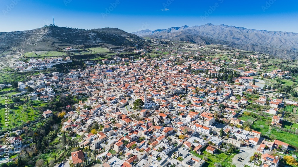 Aerial bird eye view of famous landmark tourist destination valley Pano Lefkara village, Larnaca, Cyprus. Ceramic tiled house roofs, greek orthodox church at south of Troodos hills, Kionia, from above