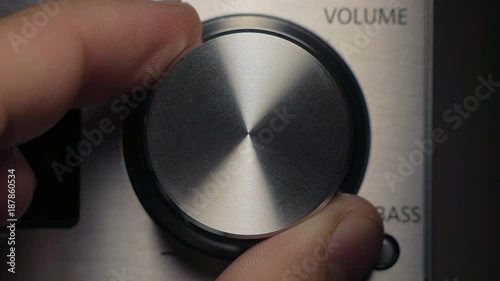 The man adjusts the volume