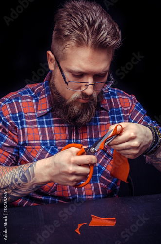 Leather Tanner creates a new leatherwork at the tanner shop photo