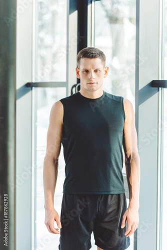 portrait of young man in sportswear in gym