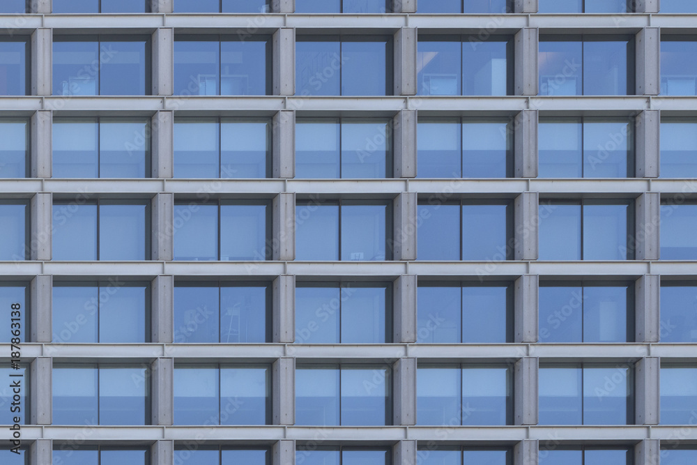 Background image of a glass windows facade of an office building.