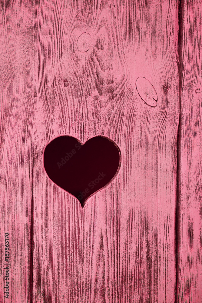 Heart carved in a red wooden board. Background. Heart carved in a red wooden board. Background.