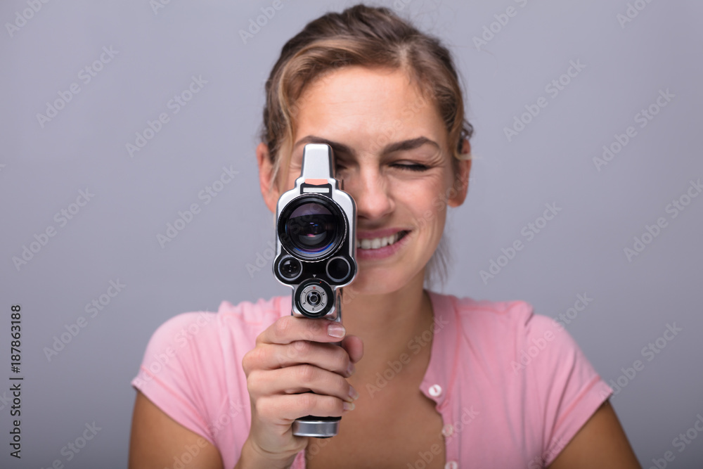 Woman Looking Through Lens Of Retro Camera Woman Looking Through Lens Of Retro Camera