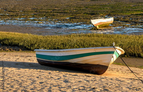 Boat ashore on dry river bed during drought