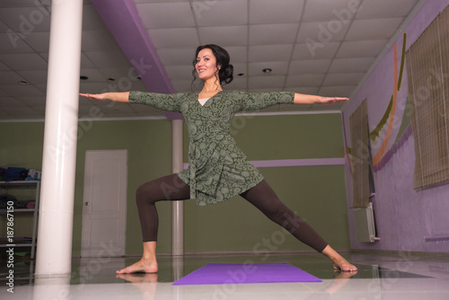 Yoga trainer practicing yoga in fitness class