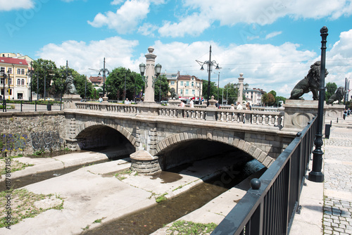 urban landscape with a bridge, buildings, people
