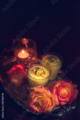 Thandai in the glass with roses and candle photo