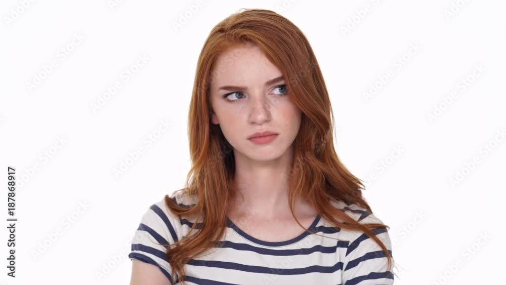 Displeased redhead young lady isolated over white wall background looking camera Displeased redhead young lady isolated over white wall background looking camera