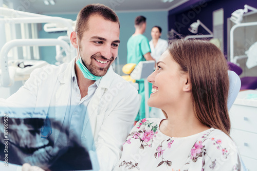 Dentist explaning oral x ray to patient