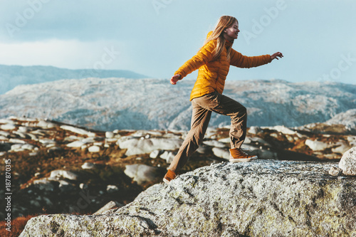 Happy Woman running outdoor in mountains Travel healthy Lifestyle concept adventure positive emotions and motivation active vacations in Norway