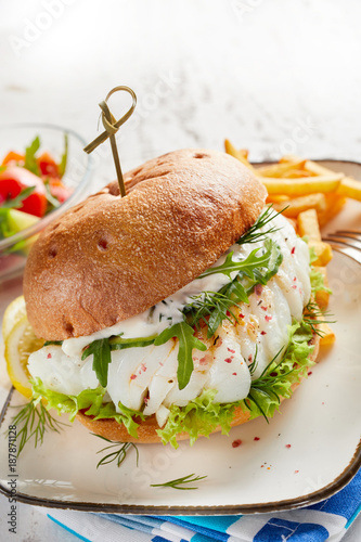 Close-up of fish burger served with French fries