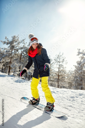 girl snowboarder on mountain slope, ski resort