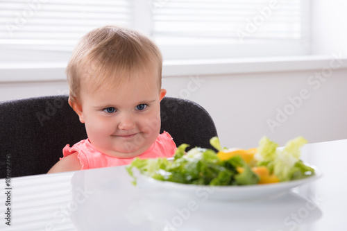 Cute Baby Looking At Food In Plate