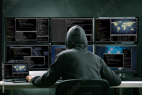 Hacker Using Multiple Computers For Stealing Data Fototapeta