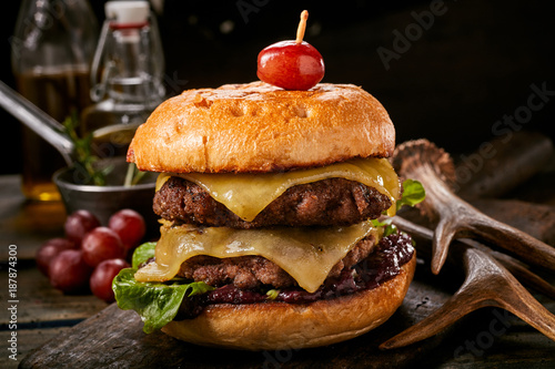 Delicious double venison cheeseburger with olives