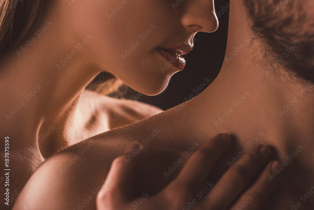 Fotografie cropped view of sensual couple, on brown