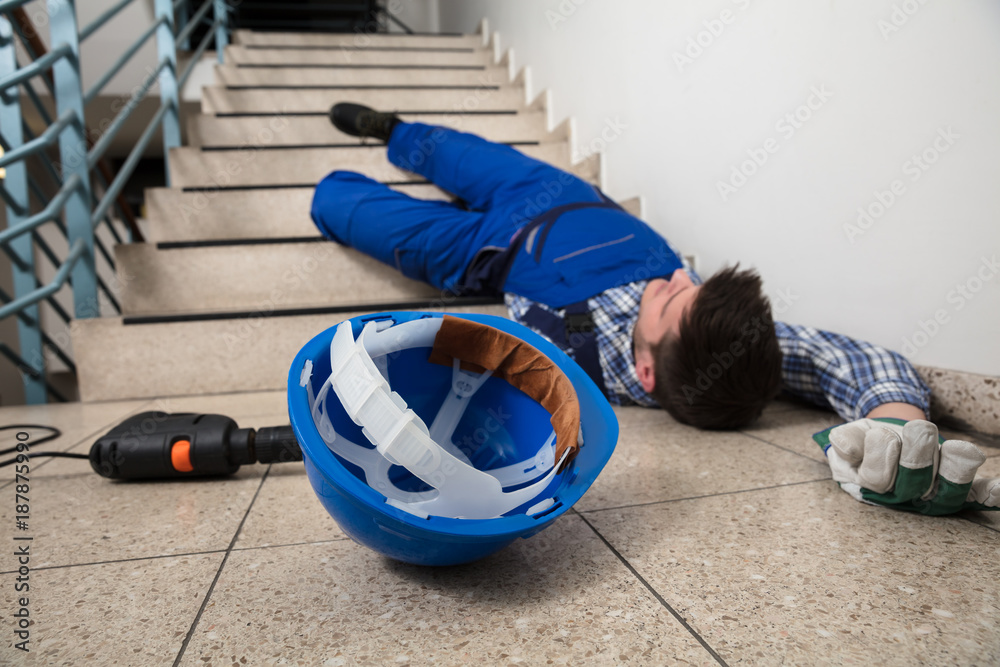Handyman Lying On Staircase - obrazy, fototapety, plakaty 