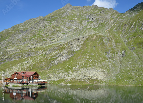 Mountain hut (romanian Cabana Balea Lac) built on a glacial lake in Carpathians .