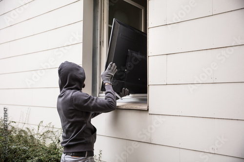 Robbers Stealing Television Through House Window