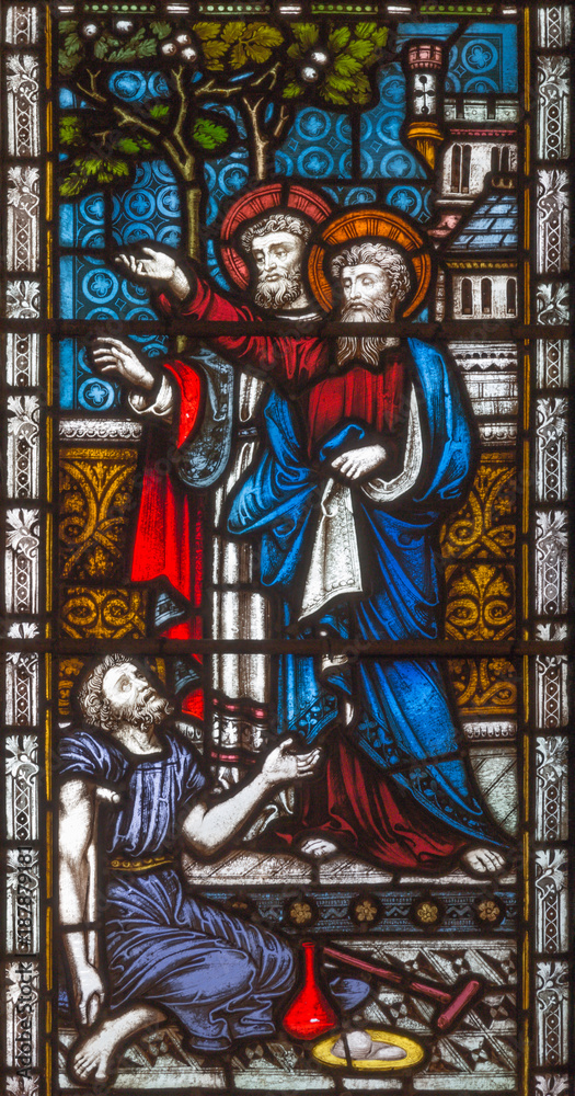 LONDON, GREAT BRITAIN - SEPTEMBER 19, 2017: The apostles Peter and John heal of paralytic in front of Temple in Jerusalem on the stained glass in St Mary Abbot's church on Kensington High Street