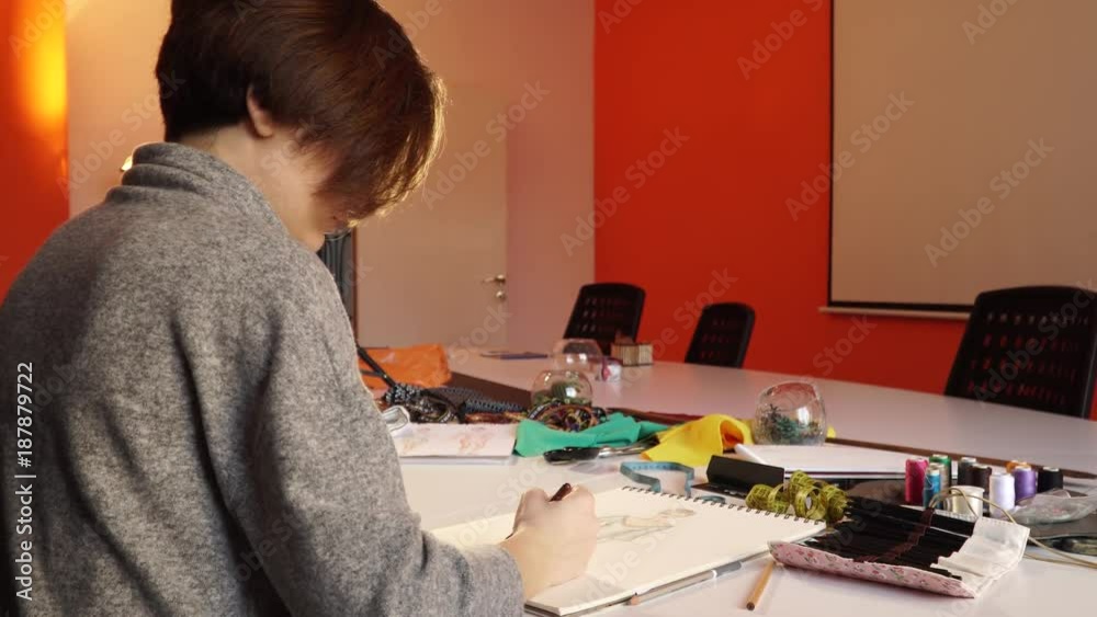 An attractive girl artist draws a sketch An attractive girl artist draws a sketch