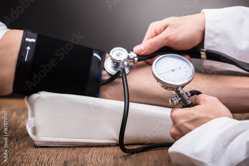 Doctor Checking Patient's Blood Pressure photo