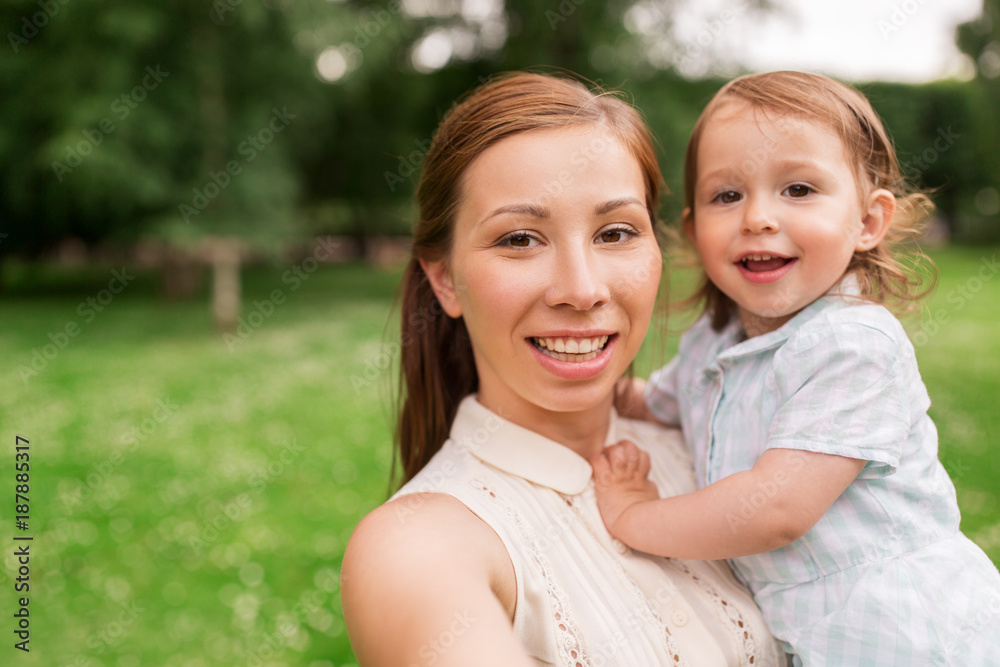 mother with baby girl taking selfie at summer park mother with baby girl taking selfie at summer park
