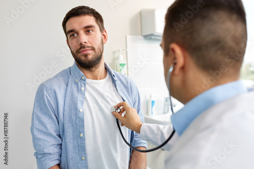 doctor with stethoscope and patient at hospital