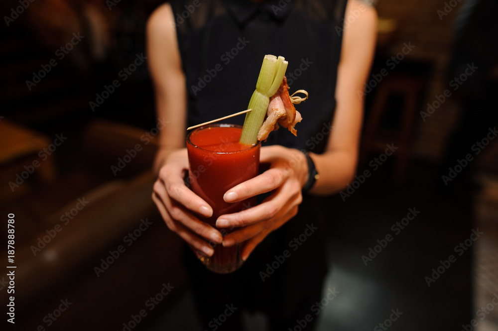 Φωτογραφία woman holding a glass of alcoholic cocktail Bloody Mary indoors