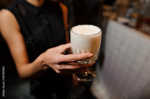 girl holds alcoholic cocktail sour mix in elegant crystal glass