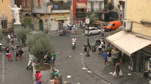 A square in Naples seen from above, cars passing by.