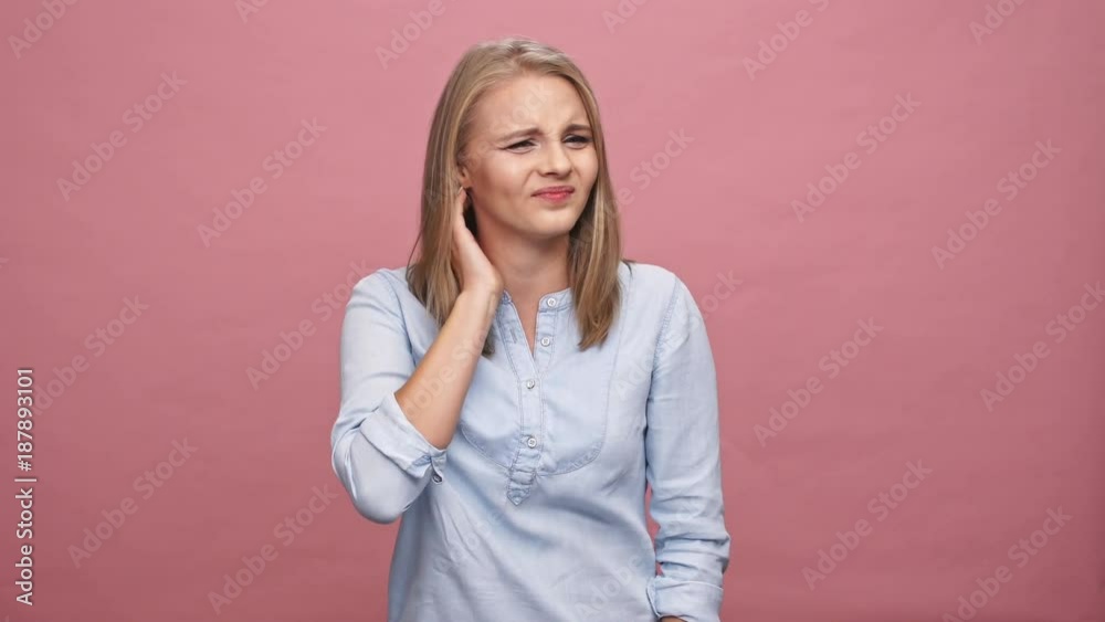 Confused blonde woman in shirt having scabies over pink background Confused blonde woman in shirt having scabies over pink background
