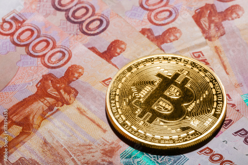 One Bitcoin on Russian rubles banknotes.