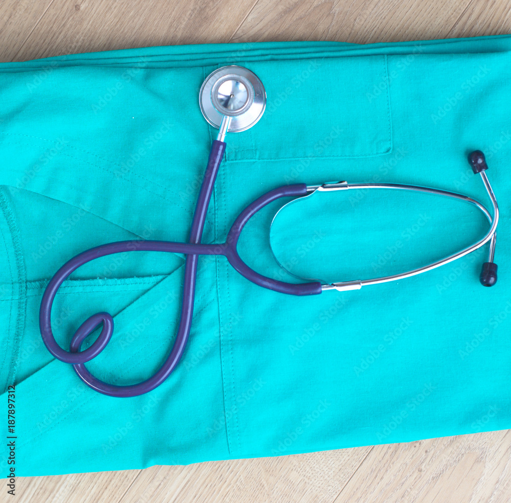 Stethoscope on a table with medical uniform Stethoscope on a table with medical uniform